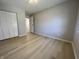 Bedroom with a closet, light walls, and neutral-toned wood floors at 8315 Woodall Dr, Indianapolis, IN 46268