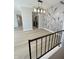 Contemporary dining area with unique wallpaper accent and sleek floors next to stairway at 8315 Woodall Dr, Indianapolis, IN 46268