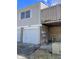 Exterior of townhome with white garage door, siding and a partial view of a wood balcony above at 8315 Woodall Dr, Indianapolis, IN 46268