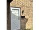 A charming white front door set against a classic brick exterior and vintage-style lighting at 8315 Woodall Dr, Indianapolis, IN 46268