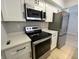 Bright kitchen featuring stainless steel appliances, light wood floors, and white cabinets at 8315 Woodall Dr, Indianapolis, IN 46268