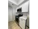 Updated kitchen features stainless steel appliances, black hardware, and white cabinets at 8315 Woodall Dr, Indianapolis, IN 46268