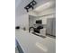 Updated kitchen featuring stainless steel appliances, white cabinets, and modern lighting at 8315 Woodall Dr, Indianapolis, IN 46268