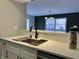 Modern kitchen sink with white counters, black faucet, and stainless steel drying rack at 8315 Woodall Dr, Indianapolis, IN 46268