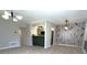 Open-concept living area with modern lighting, sleek floors, and a breakfast bar leading to the kitchen at 8315 Woodall Dr, Indianapolis, IN 46268