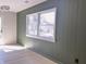 Cozy living room with sage wainscoting and white trim window showcasing natural light at 8315 Woodall Dr, Indianapolis, IN 46268