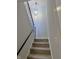 A well-lit stairway with modern black railing and new carpet leads to the upper level at 8315 Woodall Dr, Indianapolis, IN 46268