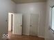 Neutral bedroom featuring wood look floors and two doors at 905 N Sheffield Ave, Indianapolis, IN 46222