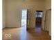 Bright living room with hardwood floors featuring view of entrance, windows and doors at 905 N Sheffield Ave, Indianapolis, IN 46222