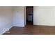 Neutral room featuring wood look floors and a doorway leading to appliances at 905 N Sheffield Ave, Indianapolis, IN 46222