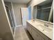 Bright bathroom features a double sink vanity, tile floors, and a tiled shower at 9616 Beckett St, Avon, IN 46123