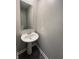 Elegant bathroom with a pedestal sink and modern faucet fixtures at 9616 Beckett St, Avon, IN 46123
