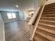 Bright living area featuring modern flooring, natural light, and stairs leading to the upper level at 9616 Beckett St, Avon, IN 46123