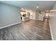 Open-concept living space with wood-look flooring and a modern kitchen with stainless steel appliances at 9616 Beckett St, Avon, IN 46123
