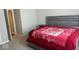 Cozy bedroom with neutral walls, a plush bed with a floral blanket, and a convenient nightstand at 10218 Cliff Ln, Indianapolis, IN 46239