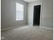 Bright bedroom featuring neutral walls, carpet, a window with blinds, and a walk-in closet at 10218 Cliff Ln, Indianapolis, IN 46239