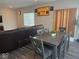 Dining area with hardwood floors, a modern table, and view into the connected living area at 10218 Cliff Ln, Indianapolis, IN 46239