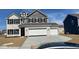 Beautiful two-story home featuring a three-car garage, gray siding, white brick, and black window shutters at 10218 Cliff Ln, Indianapolis, IN 46239