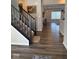 Open foyer with hardwood floors, leading to the living area and staircase with dark wood at 10218 Cliff Ln, Indianapolis, IN 46239