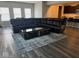 Living room with hardwood floors, a large sofa, and a stylish coffee table at 10218 Cliff Ln, Indianapolis, IN 46239