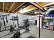 Well-equipped basement gym with various exercise machines and free weights, promoting fitness at 11185 Beardsley Way, Fishers, IN 46038