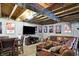 Open basement design with comfortable seating, TV, and a game table, perfect for relaxation at 11185 Beardsley Way, Fishers, IN 46038