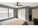 Comfortable bedroom with a ceiling fan, neutral paint, and natural light from the windows at 11185 Beardsley Way, Fishers, IN 46038