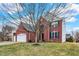 Two-story brick home with attached garage, featuring well-maintained landscaping and a mature tree at 11185 Beardsley Way, Fishers, IN 46038
