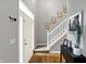 Bright foyer featuring hardwood floors, staircase, and a well-lit entryway with decorative elements at 11185 Beardsley Way, Fishers, IN 46038