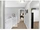 Upstairs hallway with neutral walls and carpet and white trim and doors at 11185 Beardsley Way, Fishers, IN 46038