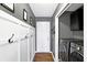 Mud room featuring wainscoting, modern laundry machines, and decoratively painted walls at 11185 Beardsley Way, Fishers, IN 46038