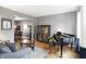 Cozy living room featuring a piano, comfortable seating, and elegant decor with hardwood floors at 11185 Beardsley Way, Fishers, IN 46038