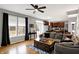 Bright living room with hardwood floors, a leather sofa, neutral paint, and an open floor plan at 11185 Beardsley Way, Fishers, IN 46038