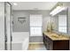 Main bathroom featuring a soaking tub, glass-enclosed shower, and double sink vanity at 11185 Beardsley Way, Fishers, IN 46038