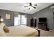 Bright main bedroom with lots of natural light, complemented by a dresser and a mounted TV at 11185 Beardsley Way, Fishers, IN 46038