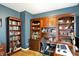 Well-lit office with built-in shelving, hardwood floors, a desk, and decoratively painted walls at 11185 Beardsley Way, Fishers, IN 46038
