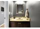 Charming powder room with framed mirror, stylish vanity, and inviting decor at 11185 Beardsley Way, Fishers, IN 46038