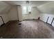 The attic bedroom features carpet floors, sloped ceilings, and a window at 1153 Villa Ave, Indianapolis, IN 46203