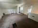 Spacious attic with carpet floors featuring sloped walls, a window, and other design elements at 1153 Villa Ave, Indianapolis, IN 46203