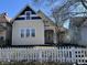 Charming two-story home featuring blue and beige exterior paint, white trim, and a lovely covered front porch at 1153 Villa Ave, Indianapolis, IN 46203