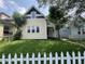 Charming two-story home with a well-maintained lawn and a white picket fence at 1153 Villa Ave, Indianapolis, IN 46203