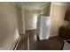 Spacious kitchen area with full size refrigerator and ample space for appliances, ready for renovation at 1153 Villa Ave, Indianapolis, IN 46203