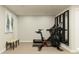 Well-equipped home gym with exercise bike, treadmill, and bench seating for fitness enthusiasts at 11557 Aubrey Ln, Fishers, IN 46040