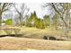 Expansive backyard featuring a deck, mature trees, and a lush green lawn at 11708 Rolling Springs Dr, Carmel, IN 46033