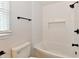 Modern bathroom features subway tile shower, a black shower head, and a white toilet at 11708 Rolling Springs Dr, Carmel, IN 46033