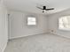 Spacious bedroom with neutral walls, plush carpet, and ample natural light from two windows at 11708 Rolling Springs Dr, Carmel, IN 46033