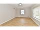 Empty bedroom with natural light, hardwood floors, and neutral paint, offering a blank canvas at 11708 Rolling Springs Dr, Carmel, IN 46033