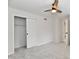 Bedroom showcasing a sliding closet door and a ceiling fan with neutral walls and plush carpeting at 11708 Rolling Springs Dr, Carmel, IN 46033