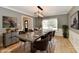 Spacious dining room with furniture, modern light fixture, and wood floors at 11708 Rolling Springs Dr, Carmel, IN 46033