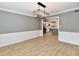 Dining room with modern light fixture and wood floors open to the kitchen at 11708 Rolling Springs Dr, Carmel, IN 46033